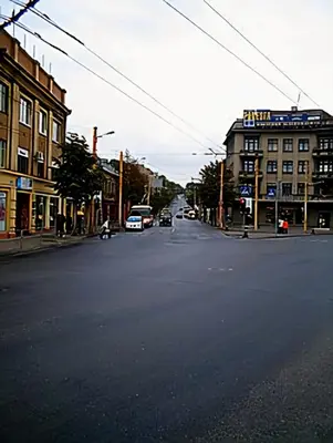 an empty city street with cars driving down the street at Kaunas Studios - RentA Studio 16 in Kaunas
