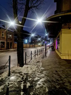 a snowy street at night with street lights at Kaunas Studios - RentA Studio 16 in Kaunas