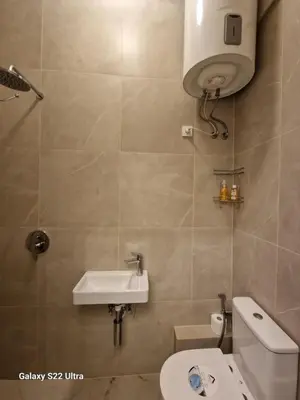 a bathroom with a white toilet and a sink at Kaunas Studios - RentA Studio 16 in Kaunas