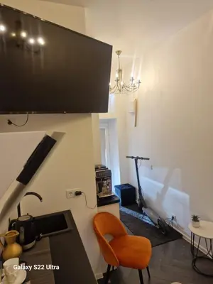a living room with a chair and a treadmill at Kaunas Studios - RentA Studio 16 in Kaunas