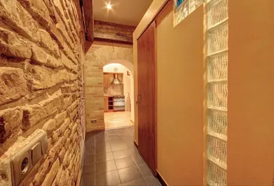 a hallway in a house with a stone wall at Sofijos apartamentai Old Town in Vilnius