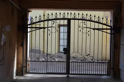 an iron gate in a doorway with a window at Sofijos apartamentai Old Town in Vilnius