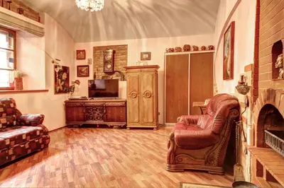 a living room with a couch and a chair and a television at Sofijos apartamentai Old Town in Vilnius