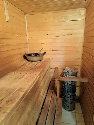 a wooden sauna with a pan on the inside of it at Patrimpo in Magūnai