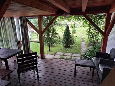 a screened in porch with a table and chairs and a view at Patrimpo in Magūnai