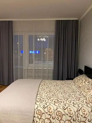 a bedroom with a large bed and a window at Quiet Comfortable Stay - Energetiku g 32, Visaginas in Visaginas