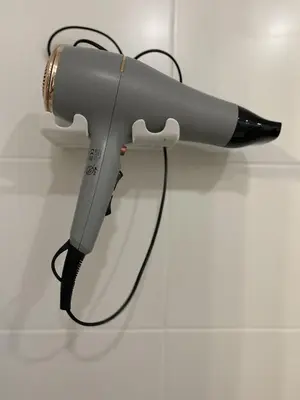 a blow dryer is attached to a wall at Quiet Comfortable Stay - Energetiku g 32, Visaginas in Visaginas