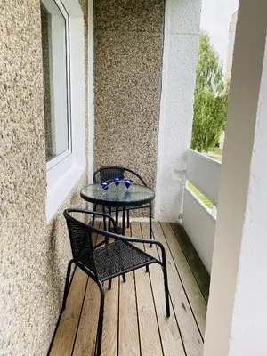 a small table and chairs on a balcony at Quiet Comfortable Stay - Energetiku g 32, Visaginas in Visaginas