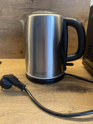 a coffee pot with a cord plugged into a laptop at Quiet Comfortable Stay - Energetiku g 32, Visaginas in Visaginas