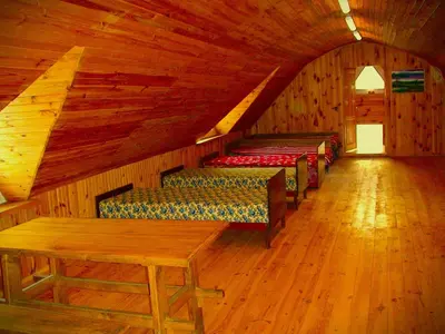 a room with four beds in a wooden cabin at Leon's farmstead in the countryside, Sauna and Jacuzzi for 16-23 people in Užuperkasis