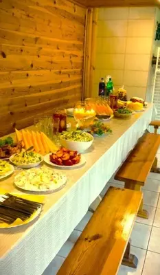 a long table with plates of food on it at Leon's farmstead in the countryside, Sauna and Jacuzzi for 16-23 people in Užuperkasis