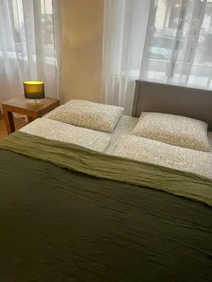 a bedroom with two beds and a window at Old Town Loft in Vilnius