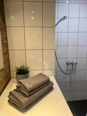 a pile of towels sitting on a counter in a bathroom at Old Town Loft in Vilnius