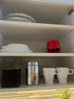 a cupboard with plates and bowls and a can at Old Town Loft in Vilnius