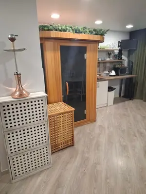a living room with a fireplace and a table at Šermukšniai in Rokiškis