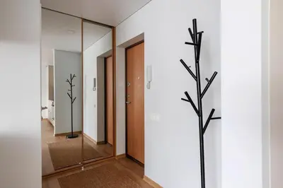 a hallway with a glass door and a tree in it at Cozy 1BD with Bathtub Close to Old Town in Vilnius