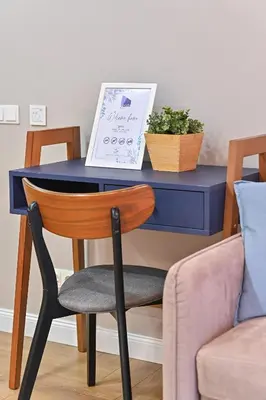 a blue desk with a chair and a plant at Serenity Space in Vilnius by Reside Baltic in Vilnius