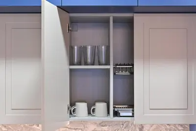 a kitchen with white cupboards with pots and pans at Serenity Space in Vilnius by Reside Baltic in Vilnius
