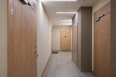 a hallway of an office with wooden doors and a hallwayngth at Serenity Space in Vilnius by Reside Baltic in Vilnius