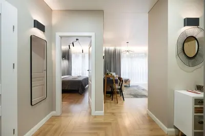 a bedroom and a living room with a bed and a mirror at Serenity Space in Vilnius by Reside Baltic in Vilnius