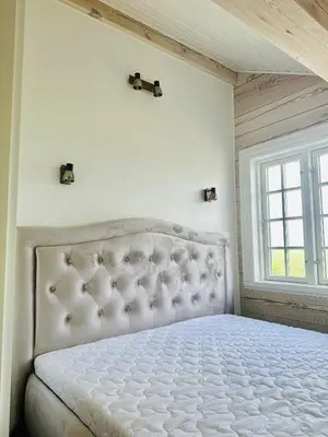 a white bed in a room with a window at Sodyba Barracuda in Kupščiai