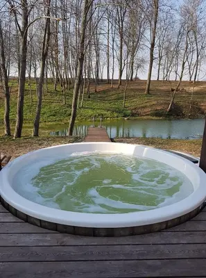 a large pool of water on a wooden deck at Sodyba Barracuda in Kupščiai