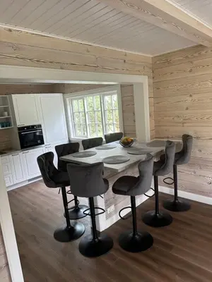 a kitchen with a table and chairs in a room at Sodyba Barracuda in Kupščiai