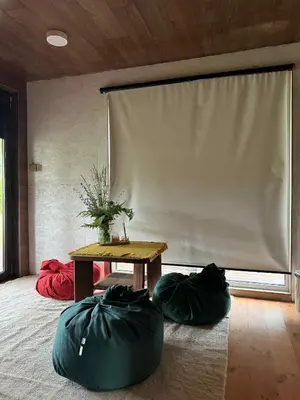 a room with a table and two bean bags at Namelis Saulės gatvėje prie Siesarties ežero in Molėtai