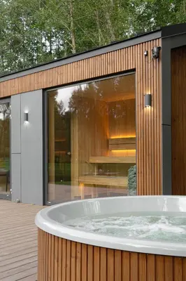 a hot tub in front of a building with a window at Dubinga River Valley House & SPA - FREE sauna in Kabakelis