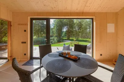 a room with a table and chairs and a large window at Dubinga River Valley House & SPA - FREE sauna in Kabakelis