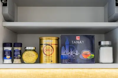 a refrigerator shelf with some food items on it at Greimo Apartments in Šiauliai