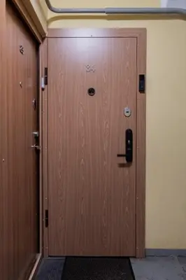 a large wooden door in a room with at Greimo Apartments in Šiauliai