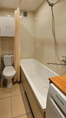 a bathroom with a tub and a toilet and a sink at Green room in Šiauliai