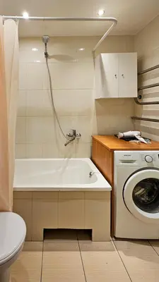 a bathroom with a tub and a washing machine at Green room in Šiauliai
