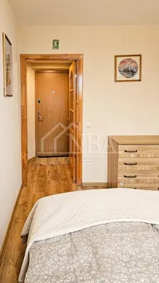 a bedroom with a bed and a dresser and a door at Green room in Šiauliai