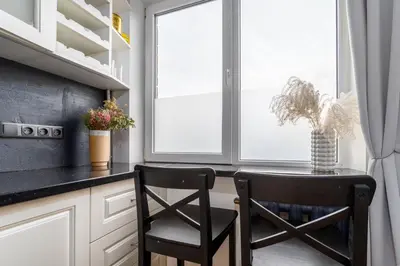 a kitchen with a small table and two chairs at Skroblu 39, cozy apartment in Vilnius