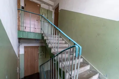 an empty staircase in an old building with a door at Skroblu 39, cozy apartment in Vilnius