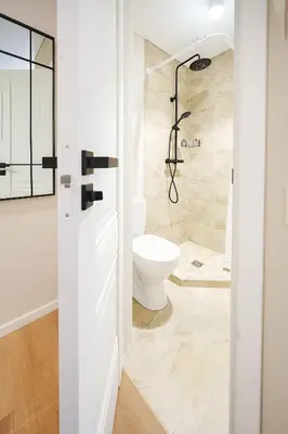 a bathroom with a toilet and a shower at Stylish studios near the city center in Vilnius