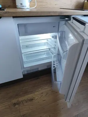 an empty refrigerator with its door open in a kitchen at Itaja apartment 73 in Šiauliai