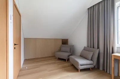 two chairs and a table in a room at Picturesque Villa RestArt by Reside Baltic in Nemenčinė