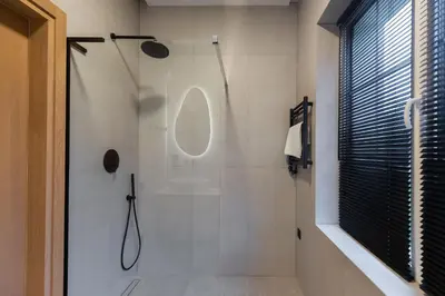 a bathroom with a shower with a glass door at Picturesque Villa RestArt by Reside Baltic in Nemenčinė