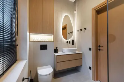 a bathroom with a toilet and a sink and a mirror at Picturesque Villa RestArt by Reside Baltic in Nemenčinė