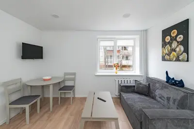 a living room with a couch and a table at Apartment Dandelion by Polo Apartments in Kaunas