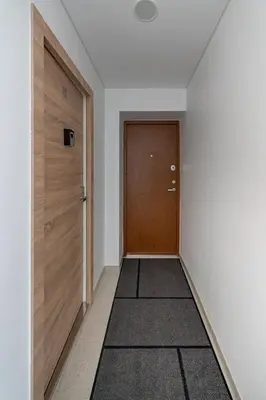 an empty hallway with a door and a rug at Studio apartment Sea by PoloApartments in Kaunas