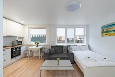 a living room with a couch and a table at Studio apartment Sea by PoloApartments in Kaunas
