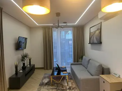 a living room with a couch and a window at WAVE Apartaments Vilnius in Vilnius