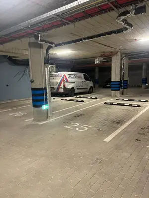 a white van parked inside of a parking garage at WAVE Apartaments Vilnius in Vilnius