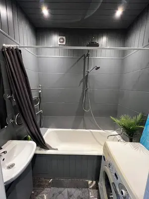 a bathroom with a tub and a sink and a shower at Cosy little studio in Šiauliai