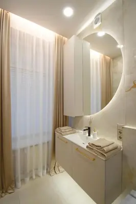 a bathroom with a sink and a mirror at Vilniaus 99 Apartamentai in Šiauliai