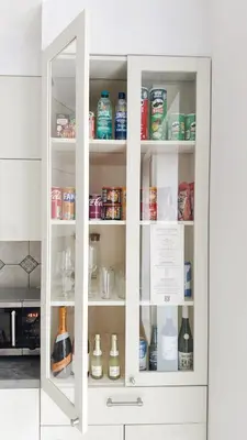 a white cabinet filled with food and drinks at Vincent Heritage Appartments - Near Clinic, Arena and Stadium in Kaunas
